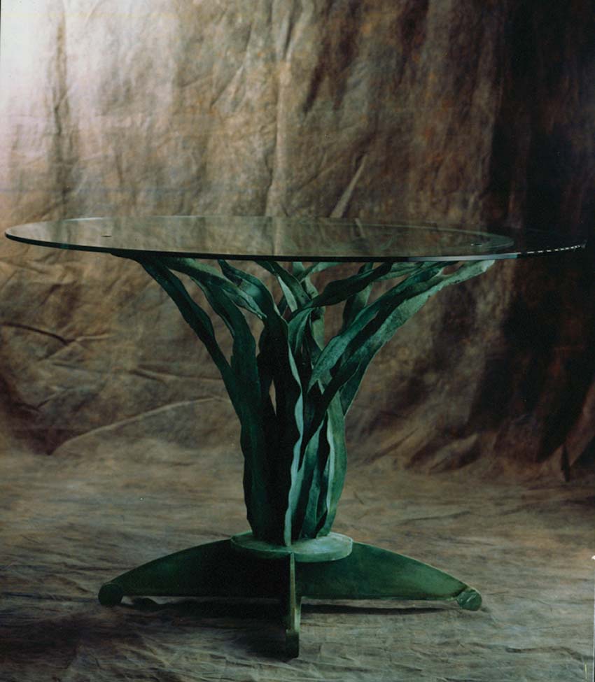 Forged bronze and glass table. Artist: Antony Donaldson